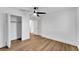 Bedroom featuring wood floors, a ceiling fan, and closet with open door at 800 N Church Ave, Mulberry, FL 33860