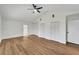 Bright bedroom featuring wood floors, white walls, ceiling fan, and double door closets at 800 N Church Ave, Mulberry, FL 33860
