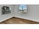 Corner bedroom featuring arched windows and wood floors at 800 N Church Ave, Mulberry, FL 33860