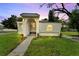 Charming exterior view of home at dusk with unique stone archway and manicured landscaping at 800 N Church Ave, Mulberry, FL 33860