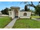 Charming exterior view of home with unique stone archway and manicured landscaping at 800 N Church Ave, Mulberry, FL 33860