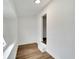 Bright hallway features wood-look floors and neutral walls leading into other areas of the home at 800 N Church Ave, Mulberry, FL 33860
