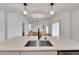 Bright, open-concept design seamlessly connects the kitchen island and living area, showcasing hardwood flooring at 800 N Church Ave, Mulberry, FL 33860