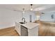Open-concept kitchen island with black faucet, stainless steel dishwasher, and seamless flow to living spaces at 800 N Church Ave, Mulberry, FL 33860