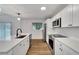 Stylish kitchen with quartz counters, stainless steel appliances, subway tile backsplash, and modern pendant lighting at 800 N Church Ave, Mulberry, FL 33860