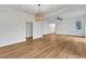 Expansive open-concept living area with wood floors, modern lighting, and access to multiple rooms at 800 N Church Ave, Mulberry, FL 33860