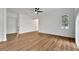 Spacious living room with light wood floors, white walls, ceiling fan and an arched window at 800 N Church Ave, Mulberry, FL 33860