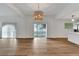 Open-concept living area with wood floors, modern lighting, and sliding doors to the backyard at 800 N Church Ave, Mulberry, FL 33860