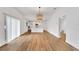 Open living space with hardwood floors, large window, and seamless transition to the modern kitchen and dining area at 800 N Church Ave, Mulberry, FL 33860