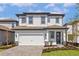 Charming two-story home with a two-car garage and beautifully landscaped front yard at 7732 Somersworth Dr, Kissimmee, FL 34747