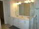 Bathroom with double sink vanity, large mirror, and tile floor at 8890 Sw 104Th Cir, Ocala, FL 34481