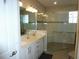 This bathroom features double sinks, a walk-in shower and sleek, modern design at 8890 Sw 104Th Cir, Ocala, FL 34481