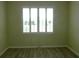 This bedroom boasts a window with bright light and wood-look floors at 8890 Sw 104Th Cir, Ocala, FL 34481