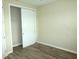 This bedroom features wood-look floors, and a closet with sliding doors for easy access at 8890 Sw 104Th Cir, Ocala, FL 34481
