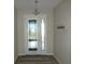 Bright entryway features a decorative glass door, coat hooks and contemporary lighting at 8890 Sw 104Th Cir, Ocala, FL 34481