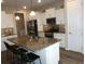 Kitchen features a granite island, stainless appliances and white cabinets at 8890 Sw 104Th Cir, Ocala, FL 34481