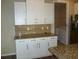 Kitchen featuring granite countertops, white cabinetry, and a view into the laundry room at 8890 Sw 104Th Cir, Ocala, FL 34481