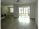 Sunlit living room features hard surface floors and access to a screened in porch at 8890 Sw 104Th Cir, Ocala, FL 34481