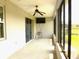 This covered patio is equipped with a ceiling fan and screens for outdoor living at 8890 Sw 104Th Cir, Ocala, FL 34481