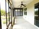 This covered patio is equipped with a ceiling fan and screens for relaxing at 8890 Sw 104Th Cir, Ocala, FL 34481