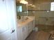 Bathroom featuring double sinks, a quartz countertop, white cabinets and a glass-enclosed shower at 8890 Sw 104Th Cir, Ocala, FL 34481