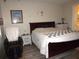 Comfortable bedroom with wood-look flooring, a bed with white linens and cozy decor at 8890 Sw 104Th Cir, Ocala, FL 34481