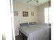 Bedroom with two beds, a window, neutral walls and decor, and wood-look floors at 8890 Sw 104Th Cir, Ocala, FL 34481