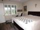 Bedroom featuring a comfortable bed, window with shutters, and cozy decor at 8890 Sw 104Th Cir, Ocala, FL 34481