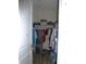 Walk-in closet featuring wire shelving and rods for ample storage, with a variety of clothing visible at 8890 Sw 104Th Cir, Ocala, FL 34481