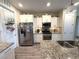 Well-equipped kitchen with stainless steel appliances, granite countertops, and ample storage at 8890 Sw 104Th Cir, Ocala, FL 34481