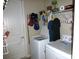 Laundry room with a washer, dryer, shelves with supplies, and plenty of room for cleaning at 8890 Sw 104Th Cir, Ocala, FL 34481
