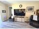 Cozy living room featuring modern furniture, wood-look floors, and natural light at 8890 Sw 104Th Cir, Ocala, FL 34481