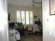 A home office featuring a ceiling fan, a window with white shutters and two computer desks at 8890 Sw 104Th Cir, Ocala, FL 34481