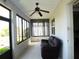 Sunroom with a dark brown reclining couch, tile flooring, and large window views of the yard at 8890 Sw 104Th Cir, Ocala, FL 34481