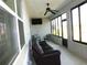 Enclosed sunroom featuring tile flooring, modern ceiling fan and glass windows for natural light and cozy seating at 8890 Sw 104Th Cir, Ocala, FL 34481