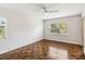Bright bedroom with gorgeous parquet floors, ceiling fan, and dual windows for natural light and backyard views at 4012 Shorecrest Dr, Orlando, FL 32804