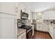 Modern kitchen with stainless steel appliances, granite countertops, and tile backsplash at 4012 Shorecrest Dr, Orlando, FL 32804
