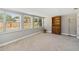 Bright living room featuring multiple windows and neutral carpet and paint at 4012 Shorecrest Dr, Orlando, FL 32804