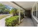 Relaxing front porch with a decorative column, lush greenery, and comfortable seating to enjoy the outdoors at 4012 Shorecrest Dr, Orlando, FL 32804