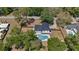 Aerial view of a home with a pool, fenced yard, and lush greenery, offering a private outdoor oasis at 1352 Charlotte St, Altamonte Springs, FL 32701