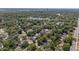 Aerial view of a neighborhood with mature trees, streets, and a glimpse of a distant lake at 1352 Charlotte St, Altamonte Springs, FL 32701