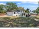 Spacious backyard with mature trees, a pool, and a covered patio for relaxing or entertaining at 1352 Charlotte St, Altamonte Springs, FL 32701