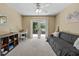 Cozy bedroom with carpet, ceiling fan, adjacent balcony, desk, couch and natural light at 1352 Charlotte St, Altamonte Springs, FL 32701