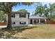 Charming two-story home with a well-manicured lawn and beautiful curb appeal under a sunny sky at 1352 Charlotte St, Altamonte Springs, FL 32701