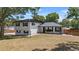 Two-story home with a well-manicured lawn and a metal roof under a sunny sky at 1352 Charlotte St, Altamonte Springs, FL 32701