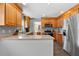 Spacious kitchen featuring wood cabinetry, stainless steel appliances, and granite countertops at 1352 Charlotte St, Altamonte Springs, FL 32701