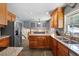 Bright kitchen with wood cabinets, stainless appliances, granite countertops, and eat-in breakfast bar at 1352 Charlotte St, Altamonte Springs, FL 32701