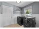 Well-organized laundry room with modern, front-load washer and dryer, plus storage shelves at 1352 Charlotte St, Altamonte Springs, FL 32701