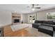 Spacious living room featuring a brick fireplace, gray sectional sofa, and access to the backyard at 1352 Charlotte St, Altamonte Springs, FL 32701