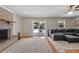 Living room with a brick fireplace, gray sectional sofa, and view of the outdoor pool at 1352 Charlotte St, Altamonte Springs, FL 32701